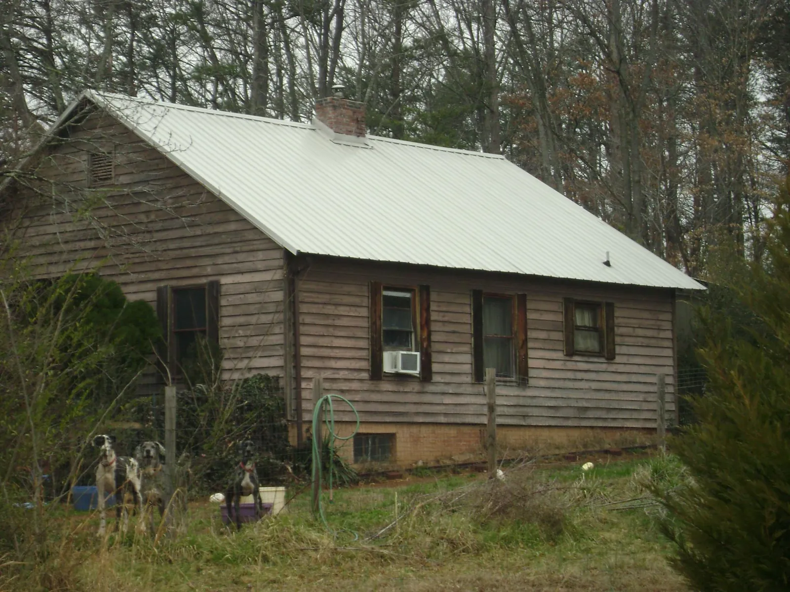 White metal roof on an old wood sided farmhouse, from a Metal Roof Installation job in Bellmore
